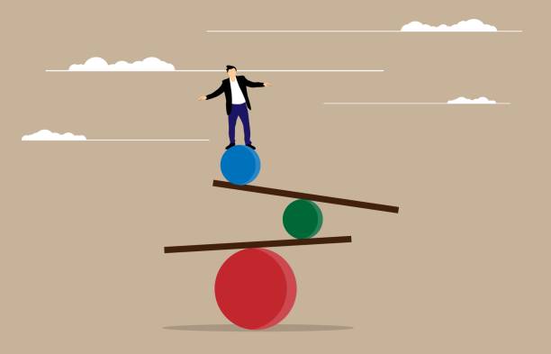 istock Businessman Trying to Find Balance on a Fragile Seesaw Construction 2187310295