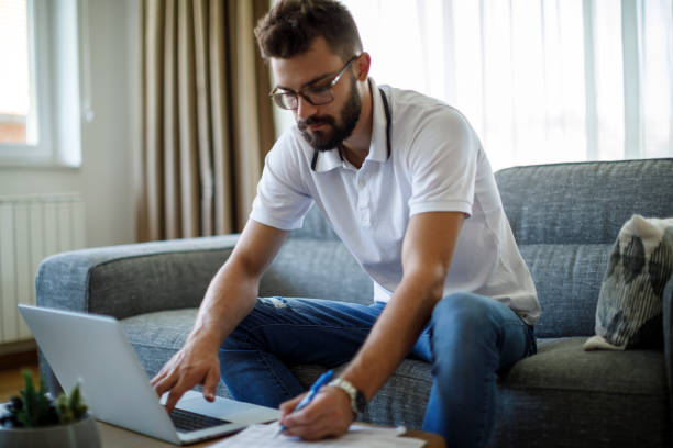 istock Young man calculating budget and finances 2187314395