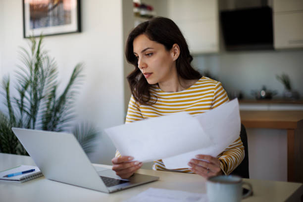 istock Young woman going throught her finances at home 2187314555