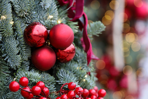 istock Christmas tree branches with red balls on golden lights background 2187314712