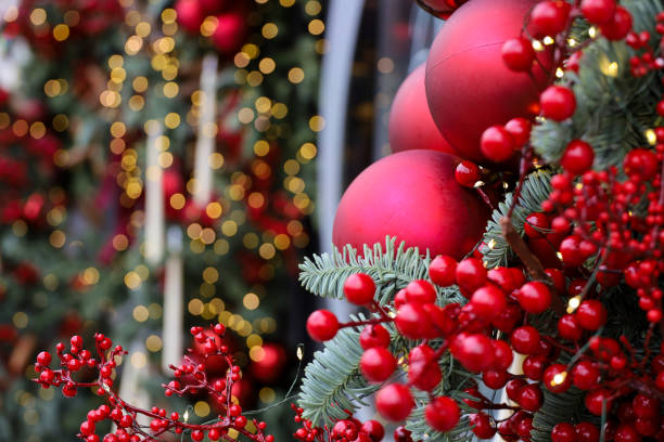 istock Christmas tree branches with red balls on golden lights background 2187314728