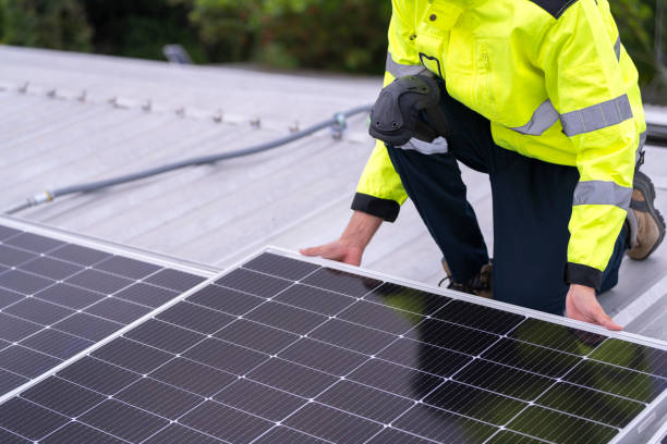 istock technician lifting a photovoltaic panel during installation, showcasing renewable energy advancement. Dressed in safety gear, reflecting a focus on green energy solutions and sustainable development. 2187314919