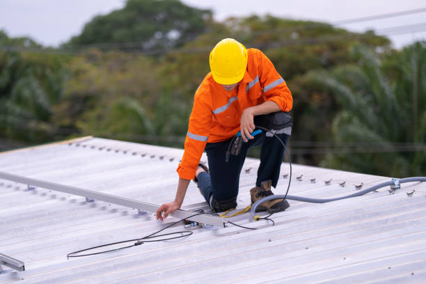 istock Technician in an orange safety uniform and helmet handling an electrical cable on a rooftop. Represents safety, professionalism, and expertise in renewable energy installations and maintenance work. 2187315566