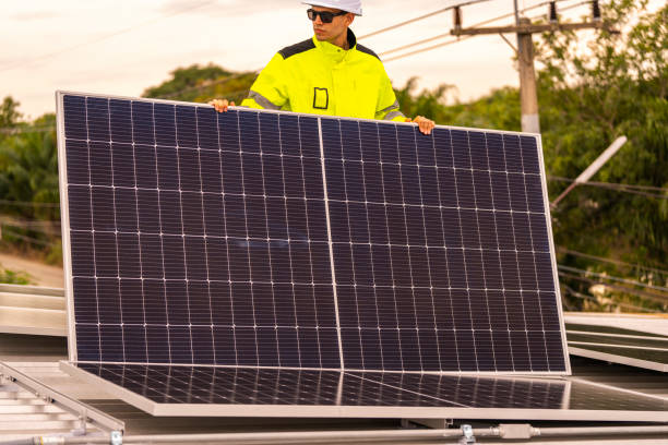 istock technician lifting a photovoltaic panel during installation, showcasing renewable energy advancement. Dressed in safety gear, reflecting a focus on green energy solutions and sustainable development. 2187316497
