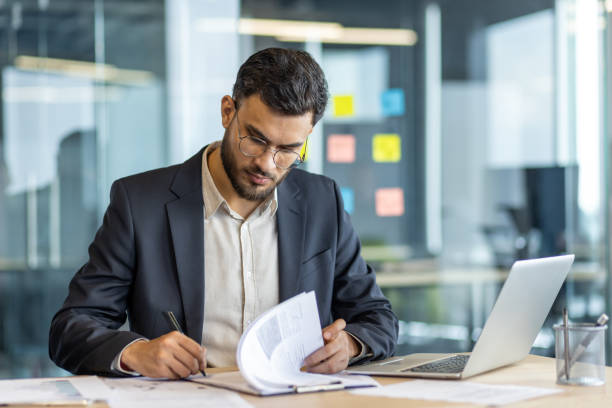 Professional in business setting signing important contracts with focused precision and dedication to work