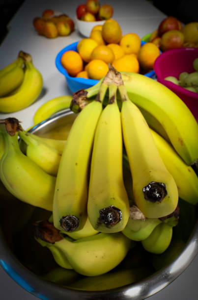Woman picking a banana bunch at market
