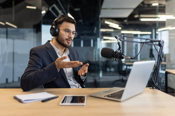 Podcaster Using A Microphone Free Stock Photo of Young podcaster use microphone during online ...