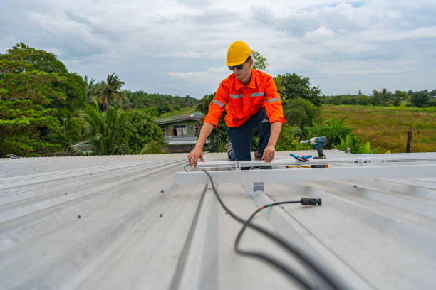 istock Technician in safety uniform and helmet kneeling on a rooftop, using a drill for precise installation work. A scene highlighting safety, professionalism, and technical expertise in construction. 2187322294