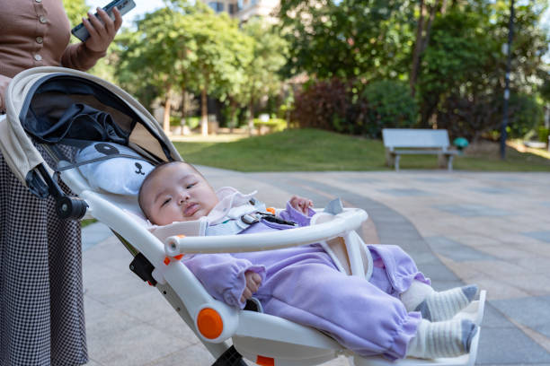 istock Mother pushing baby in stroller outdoors 2187325730