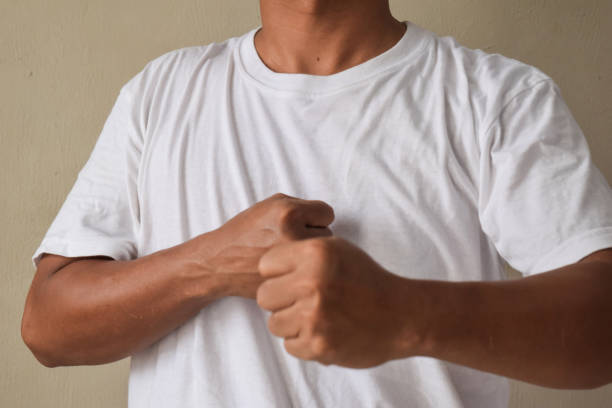 close up Angry man fists on gray background