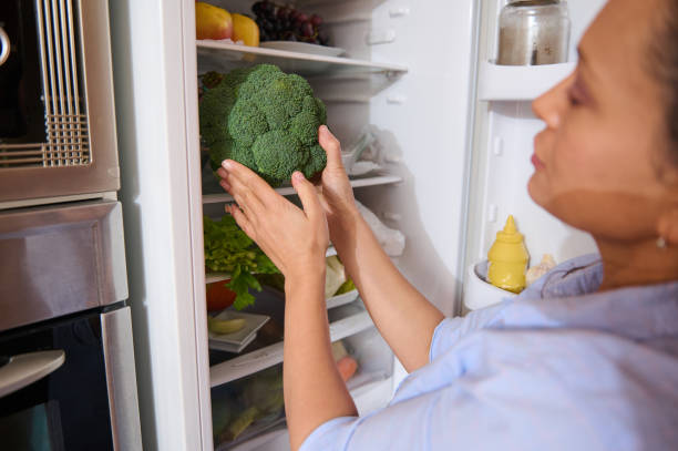 istock Woman organizing fresh vegetables in a refrigerator 2187328338