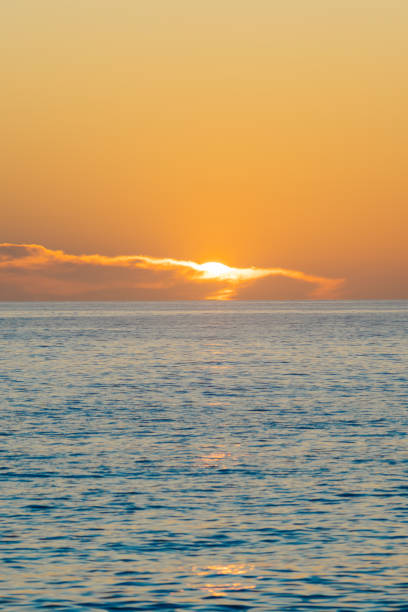 istock Coastal golden sunrise over horizon 2187328562