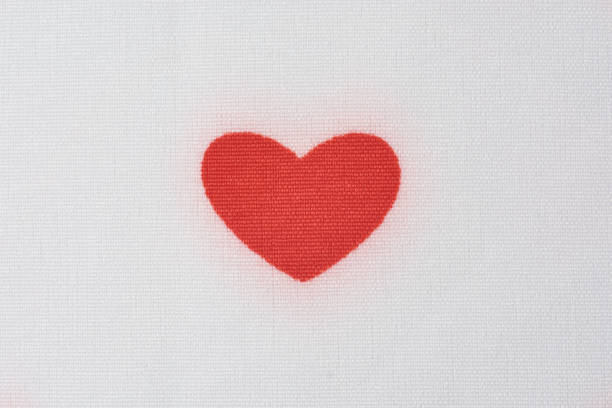 istock close-up of red heart on white fabric 2187328941