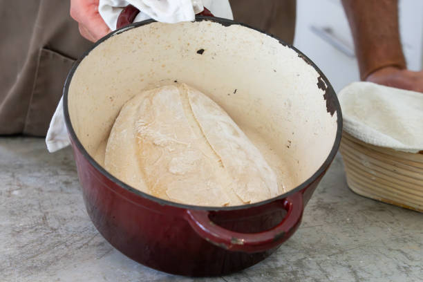 istock Soughdough bread mixing and baking here baked in Dutch oven and ready for browning off. 2187329293