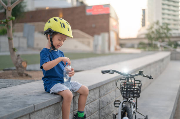 istock Thirsty young cyclist taking a water break outdoors. 2187333053