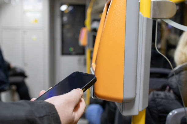 istock person scanning smartphone on bus validator for contactless payment, emphasizing modern technology, urban transportation, and cashless travel 2187333812