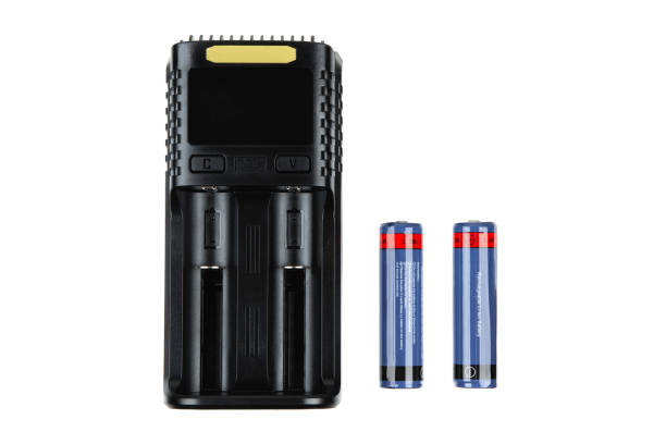 istock Battery charger with two blue and red rechargeable batteries, isolated on a white background, electronic device, power supply, energy storage. 2187335875