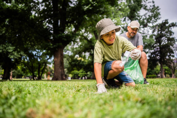 istock Child boy doing garbage collect with father on the public park 2187339298
