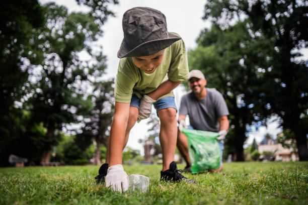 istock Child boy doing garbage collect with father on the public park 2187339308