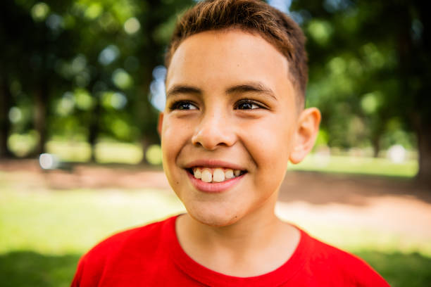 istock Boy looking away contemplating on the public park 2187339592