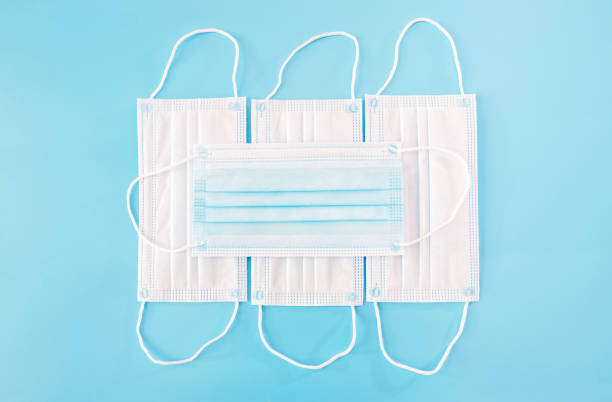 istock medical protective masks on a blue background. 2187339688