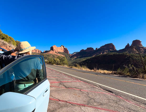 istock Sedona, AZ: Woman on Road Trip, Parked Car, Red Rocks 2187339762