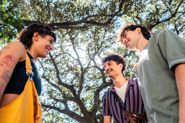 istock Young friends talking at public park 2187339939