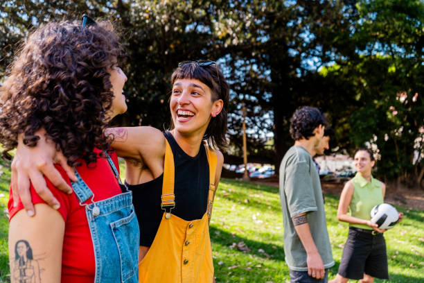 istock Female friends talking at public park 2187340157