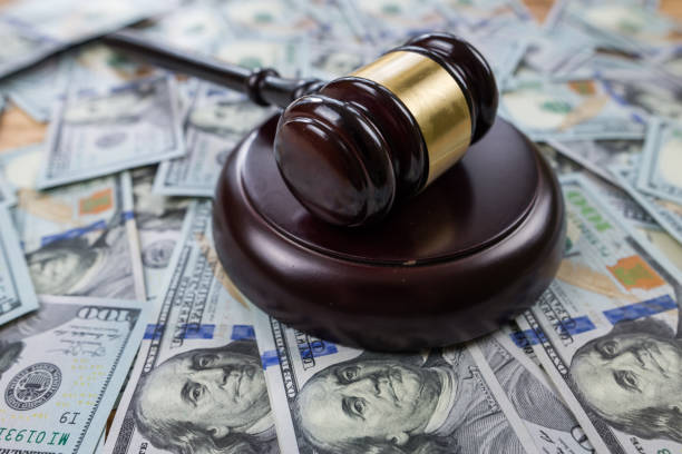 istock judge's gavel on dollars.judge's gavel on banknotes. judicial corruption and justice. resolution of financial disputes. restoration of dogs. bankruptcy. 2187340435
