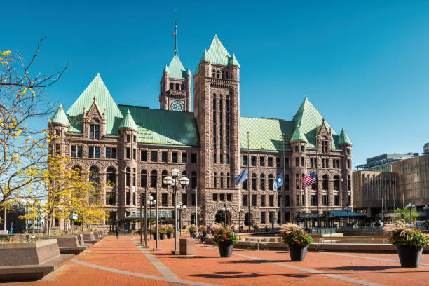 A domed historic church with classical columns stands in contrast to the modern office buildings surrounding it in the city.