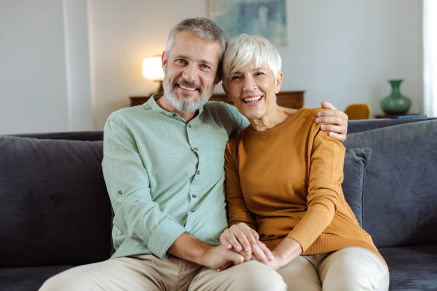 istock Smiling elderly spouses in love posing on home sofa 2187344850