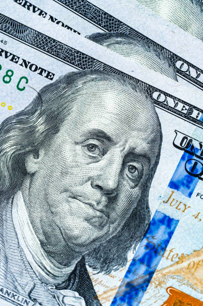 istock Close-up of a hundred-dollar bill featuring Benjamin Franklin. The image highlights intricate details of the currency, showcasing its vibrant colors and textures. Perfect for financial themes. 2187345233