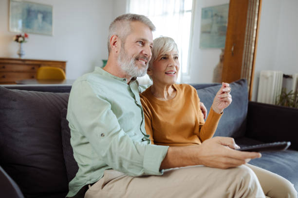 istock Senior couple watching TV at home 2187345582