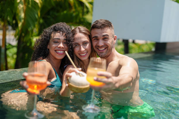 istock Joyful Friends with Drinks in Pool Enjoyment 2187345717
