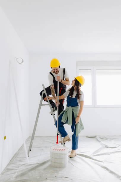 istock Young workers with painting tools indoors. Room renovation 2187346359
