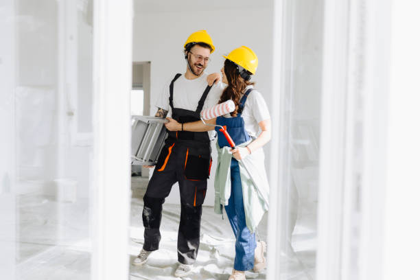 istock Young workers with painting tools indoors. Room renovation 2187346428