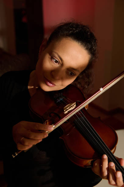 istock Musician playing violin with emotional expression and focus 2187347346