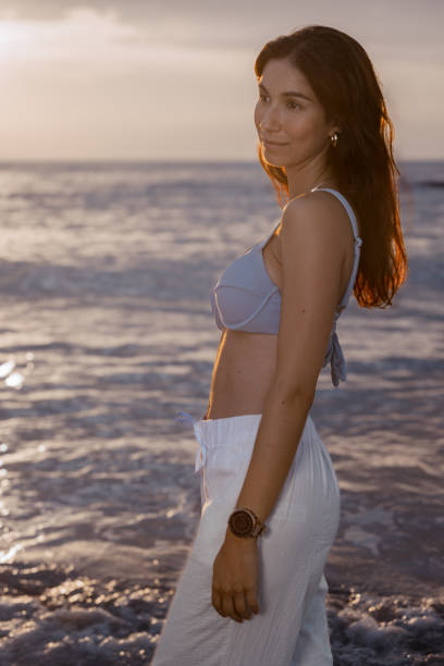 istock woman on vacation at the beach. 2187347888