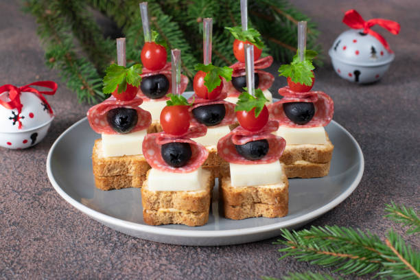 istock Canape with cherry tomatoes, sausage, cheese and black olives 2187351000