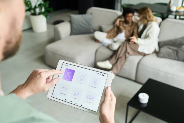istock Person Managing Smart Home Device in Living Room 2187351152