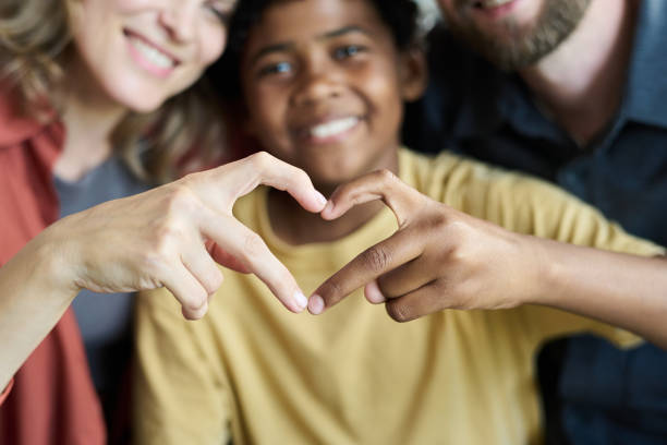 Creating Heart Shape Gesture with Family Members Smiling