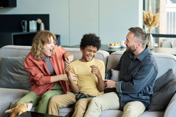 istock Laughing and Bonding Together on Living Room Couch 2187351192