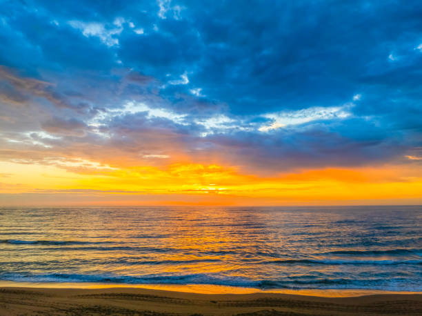 istock Pretty Sunrise at the seaside with rain clouds 2187351993