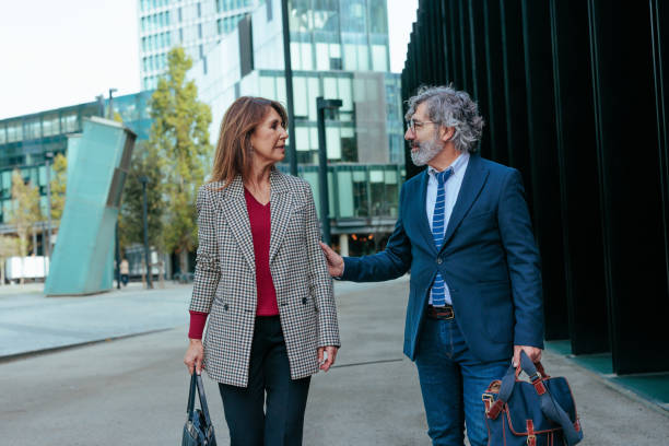 istock Business partners walking and talking in a modern city 2187353046