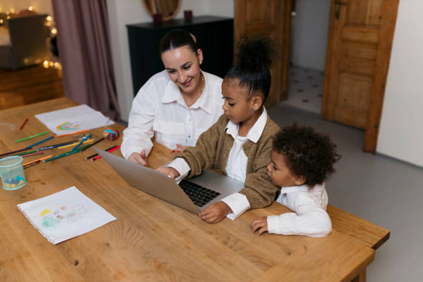 istock Family learning together at the table with laptop 2187353327