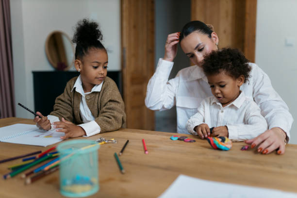 istock Mother with kids playing and drawing at home 2187354184