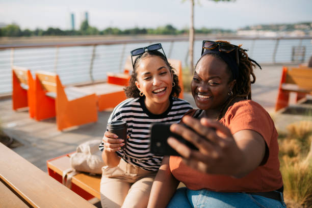 istock Two women friends at cafe taking selfie 2187355768