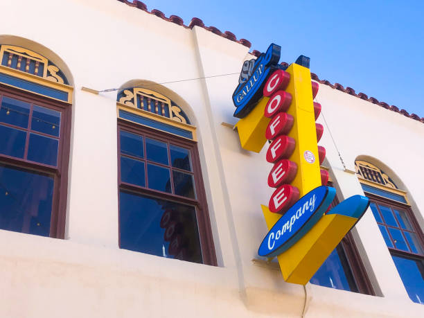 Gallup, NM: A colorful vintage sign on an old building with arched windows on Coal Street in downtown Gallup.