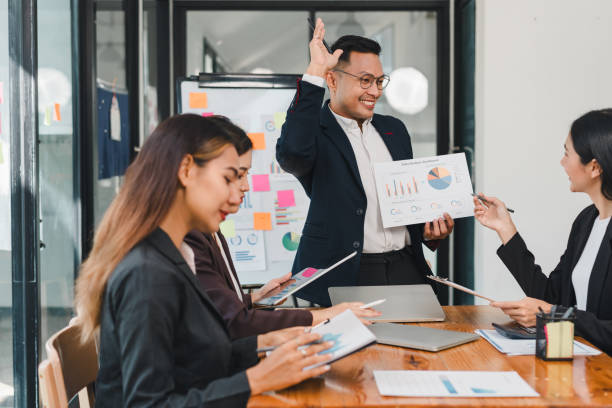 istock Business meeting with diverse professionals discussing charts and graphs, showcasing teamwork and collaboration in modern office setting 2187367015