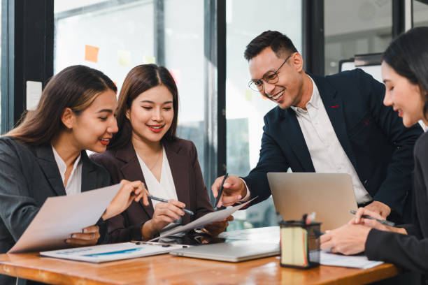 istock Efficient business meeting with diverse professionals collaborating on documents and sharing ideas. atmosphere is focused and productive, showcasing teamwork and communication 2187367023